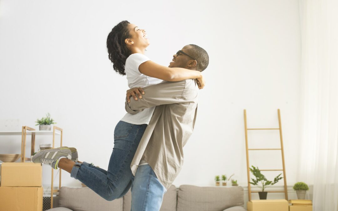 African american millennial couple hugging and whirling
