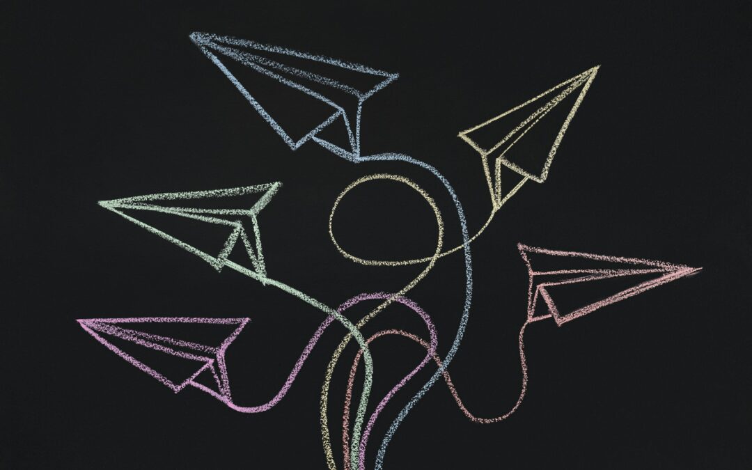 Drawn paper planes with route trace on chalkboard background